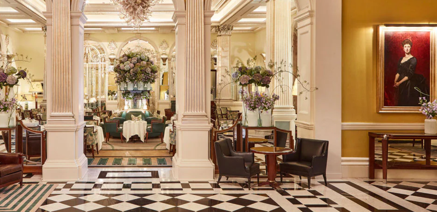 Luxury hotel lobby with marble floors, ornate columns, and elegant seating areas