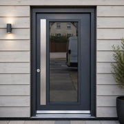 Modern black security door with glass panel and stainless steel handle on wooden facade