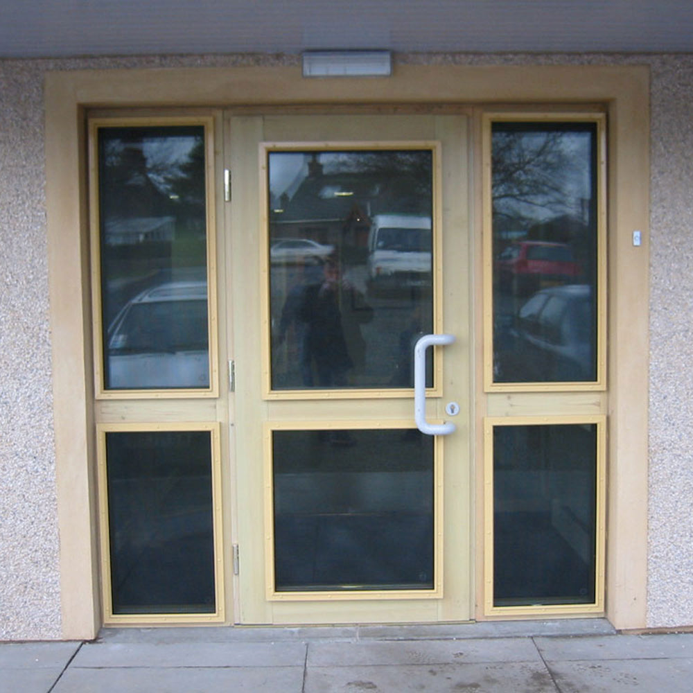 CrimeShield perforated window security mesh installed on a wooden glass door system