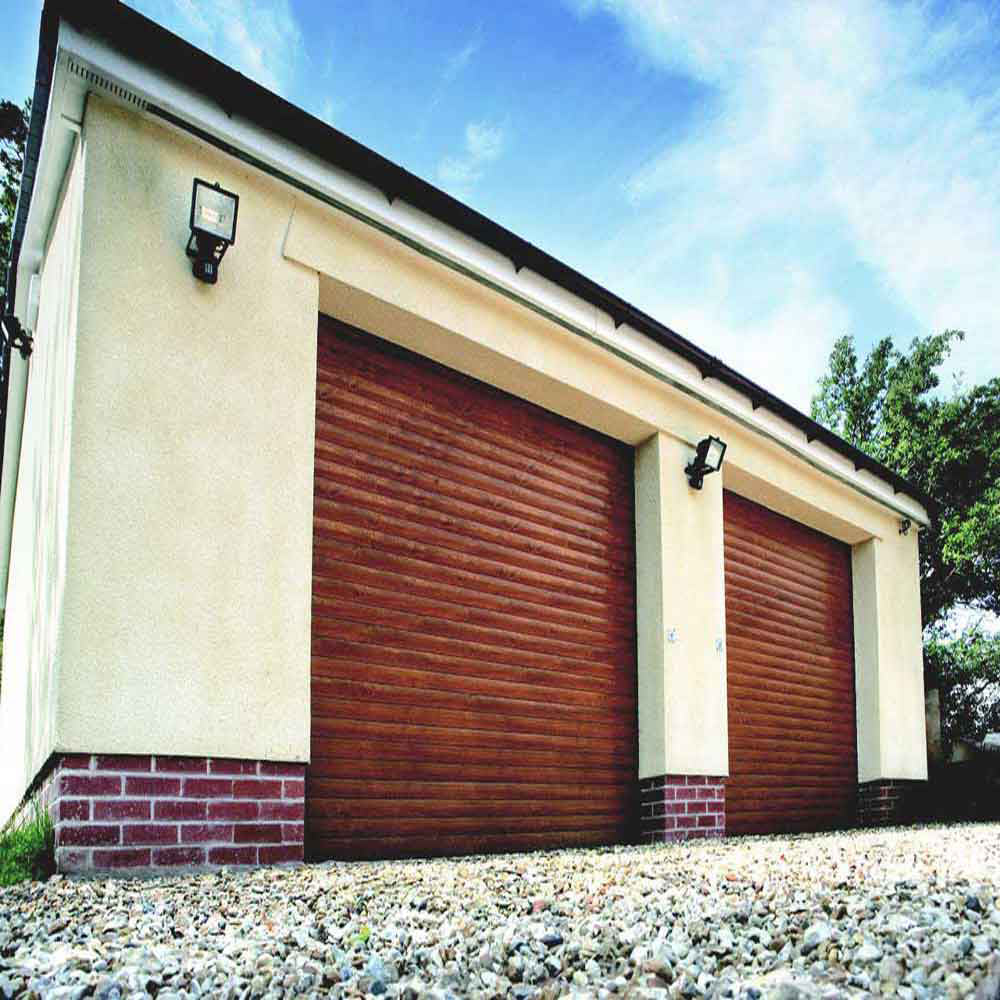 Wooden finish roller shutter doors installed on a modern cream-colored garage building.